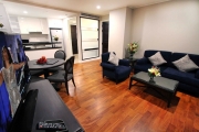 The living room provides ample space for the whole family and comes with a large flat screen LCD television